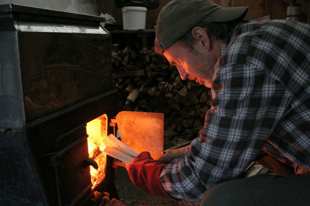 Hopkins Memorial Forest manager Drew Jones stokes the evaporator.