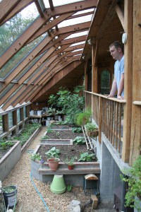 The greenhouse at Sirius Ecovillage uses solar exposure, a shared wall with a house, and thermal mass to stay warm in the winter.