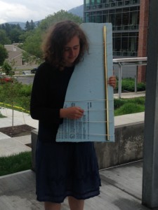 Sammi Stone holds one of the many instruments she has made using recycled items.