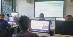 Patrick Gray giving students a refresher on how to use the Audacity editing and sound mixing software