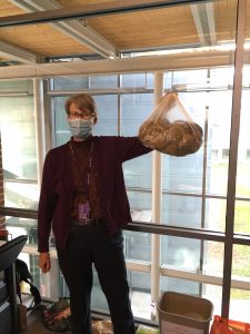 Lucy Green holding up a bag of compostable materials