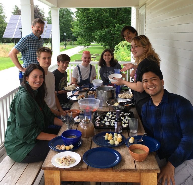 Group of people sharing a meal on the envi center porch