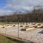 Image of community garden plots when they were first built, empty and with a light dusting of snow
