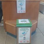 Mask recycling bin in front of bench