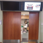 Image of lit-up monitor above an entryway into Paresky dining hall