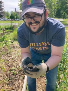 Evan Chester smiles while holding a frog