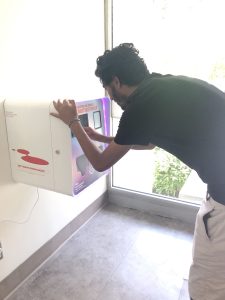 Student using GenCo refill stationtouchscreen