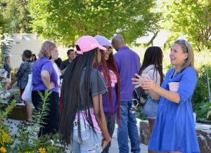 Katherine Meyers talks in an animated fashion with two first-year students
