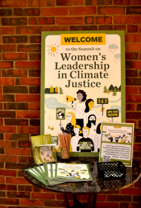 Sign against brick wall the says "Welcome to the summit on women's leadership in climate justice"