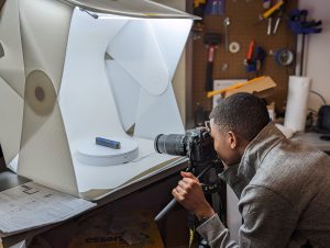 Milton takes photo of object in a white box