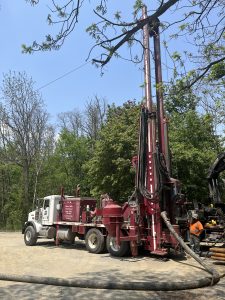 Truck with tall red drilling equipment attached