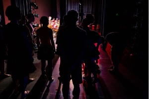 Dark silhouettes on a stage